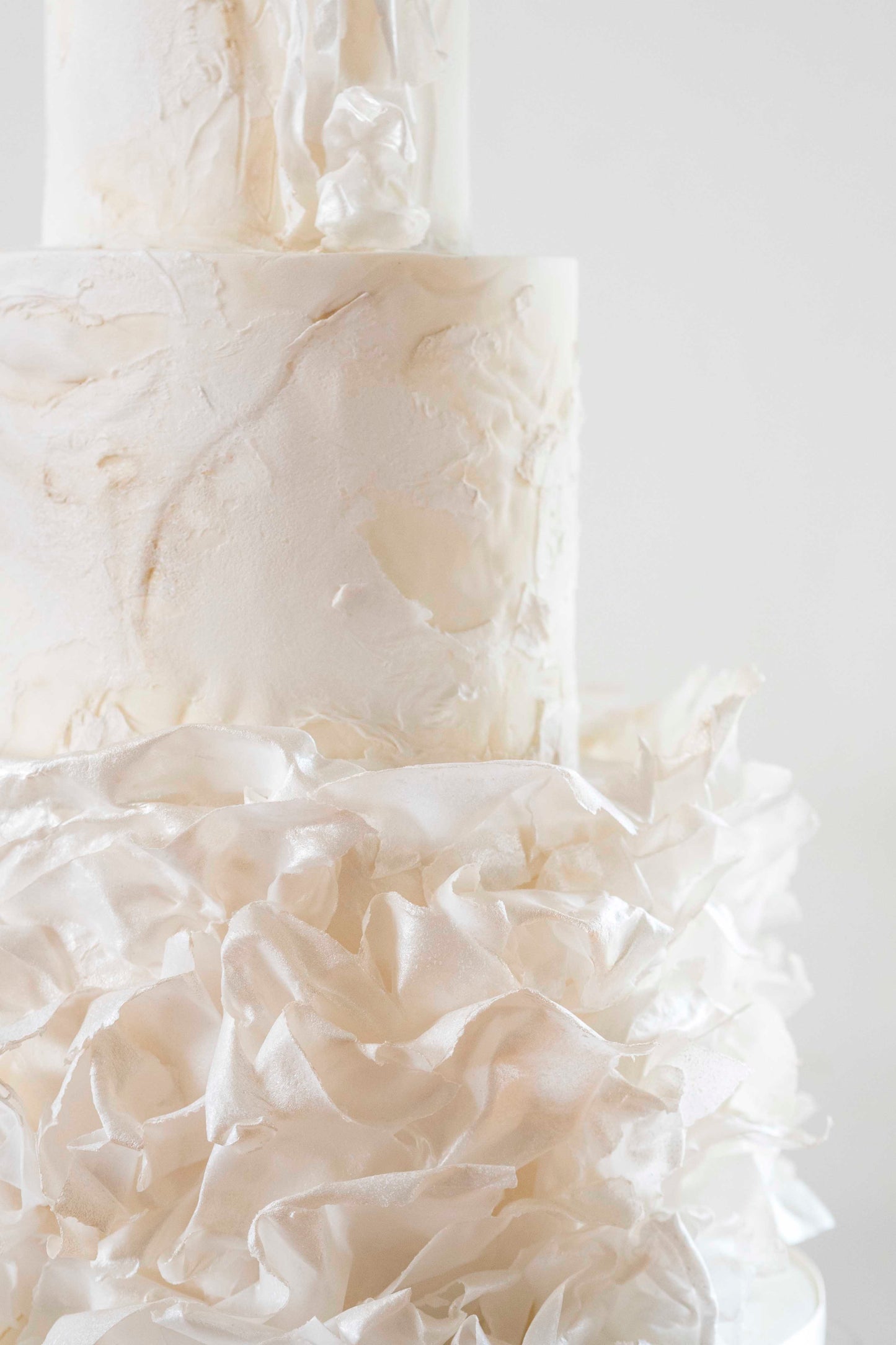 Contemporary wedding cake with modern ruffle, textured finish and dreamy ethereal look