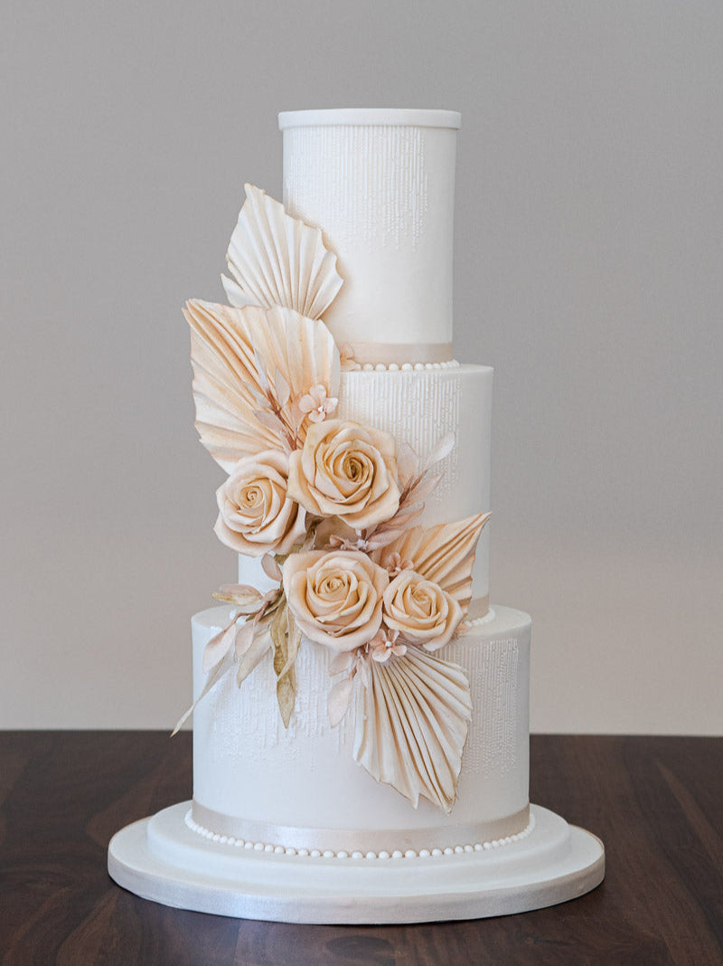 Wedding cake with a warm neutral colour palette and a touch of 1920's art deco glamour, inspired by the trend for combining delicate fresh blooms with architectural dried flowers. By Saddleworth based Union Cakes