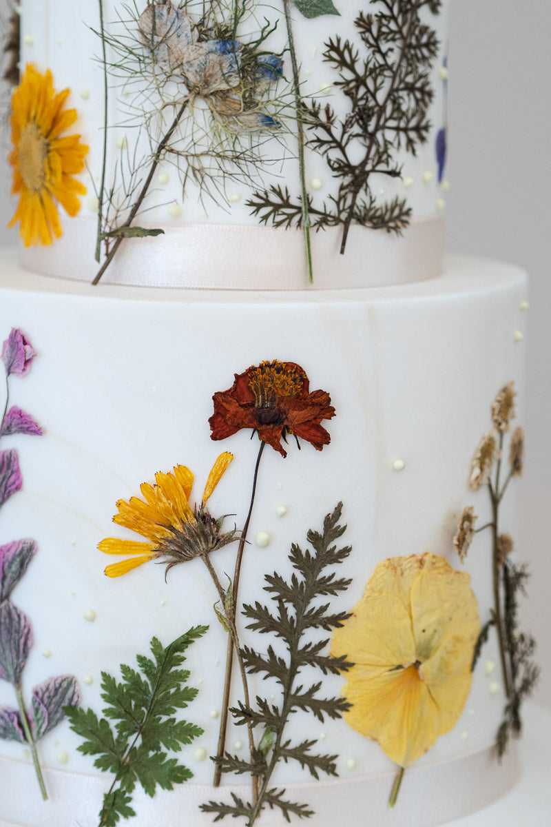 detail of pressed wild flower wedding cake, Manchester, England