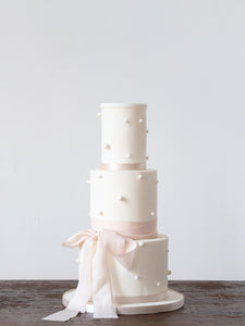 Statement pearl embellished wedding cake with a delicate silk ribbon by Saddleworth based Union Cakes