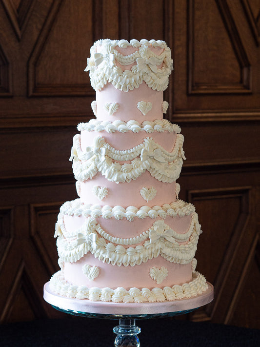 Peach and Ivory wedding cake with Lambeth piping in royal icing