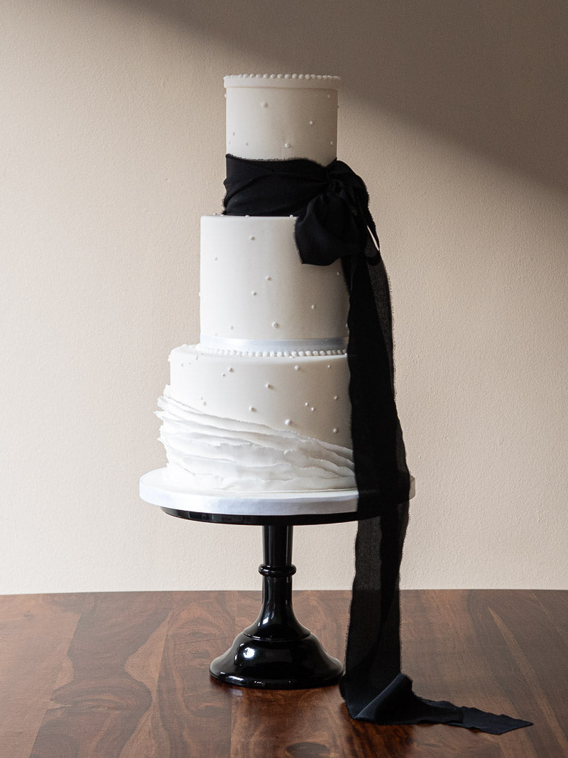 Three Tier Wedding Cake with minimal iced detail and a luxurious raw silk ribbon