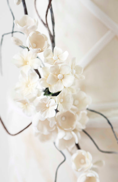 Delicate handmade white sugar blossom detail from contemporary beach inspired wedding cake