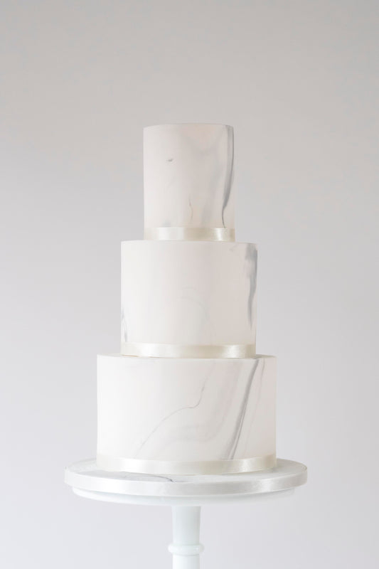Not quite naked wedding cake with marbled finish