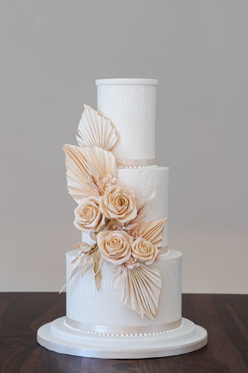 Wedding cake with a warm neutral colour palette and a touch of 1920's art deco glamour, inspired by the trend for combining  delicate fresh blooms with architectural dried flowers. By Saddleworth based Union Cakes