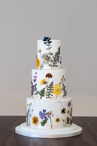 Nature influenced, pressed edible flower wedding cake.  Think wild flower meadows and hazy summer days.
