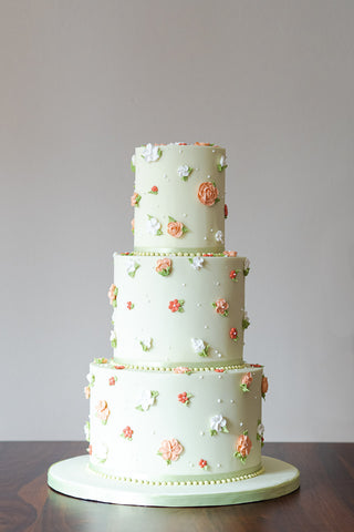 A nostalgic, retro wedding cake in sage green inspired by the tiny blooms of ditsy prints