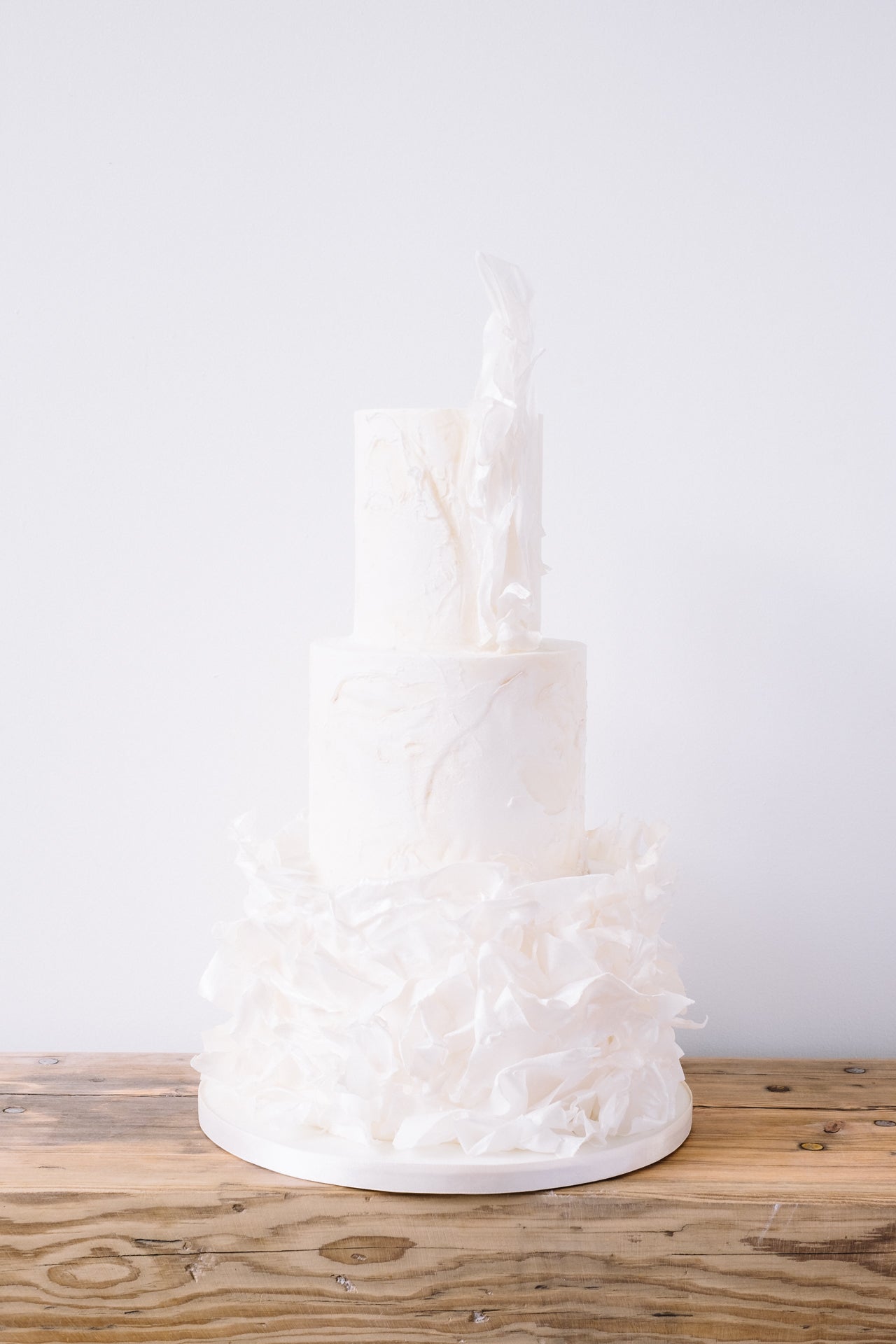 Textured three tier contemporary wedding cake with a modern ruffle and ethereal feel by Saddleworth based Union Cakes