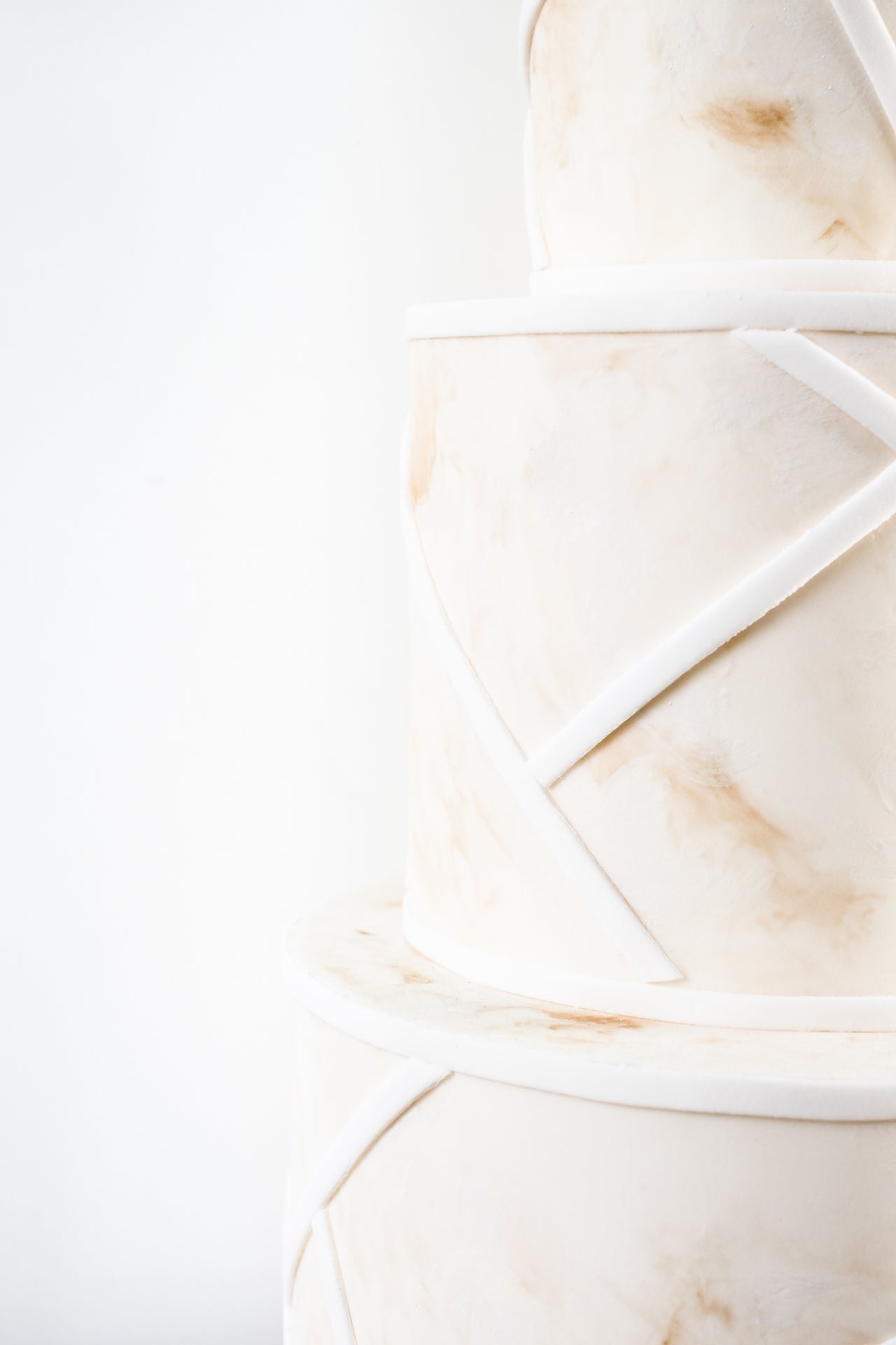 Coastal style modern, affordable wedding cake with a delicate spray of sugar flowers