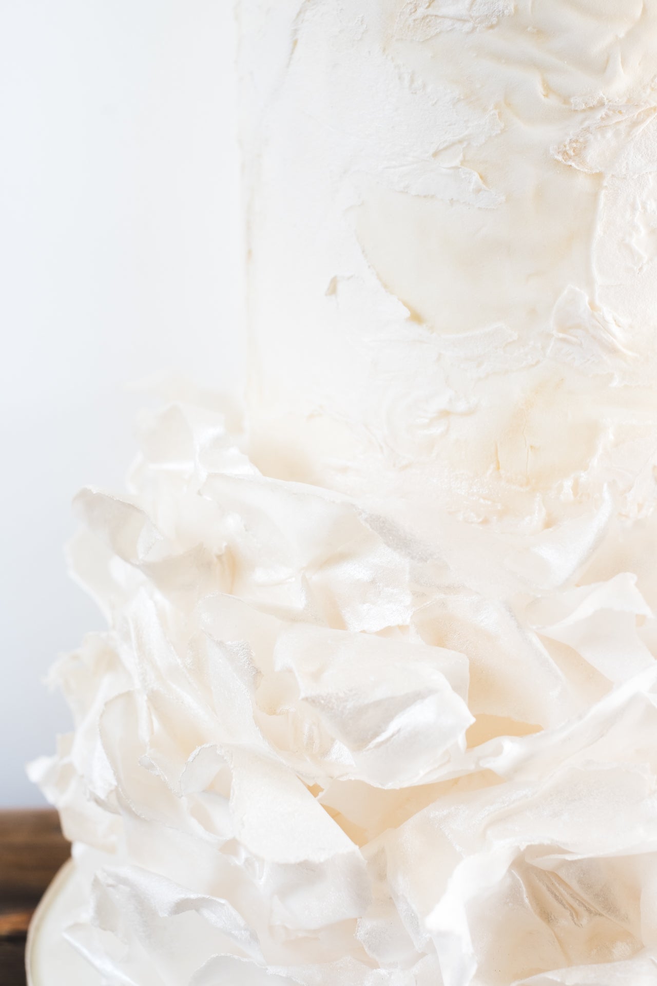 Contemporary wedding cake with modern ruffle, textured finish and dreamy ethereal look
